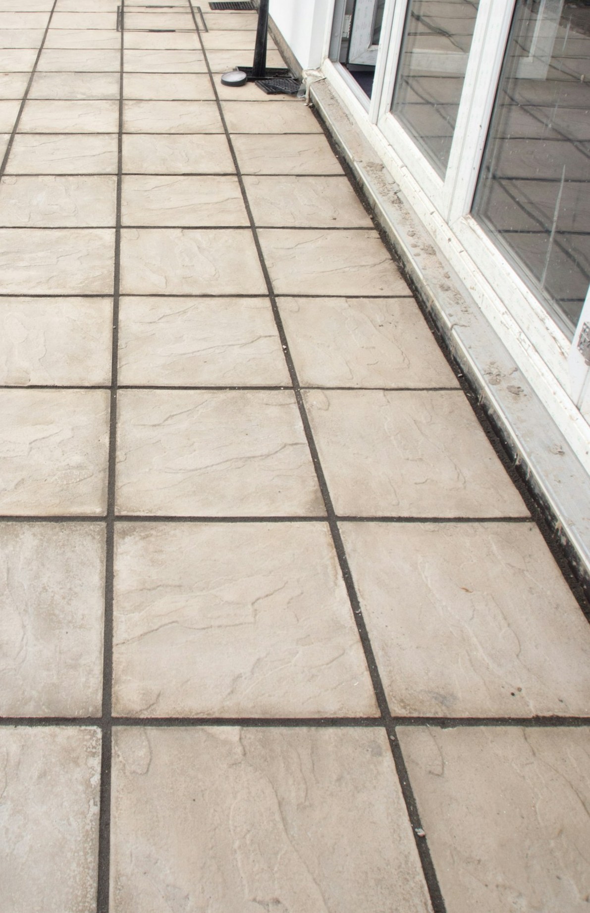 Newly laid paving flags tight to a patio door